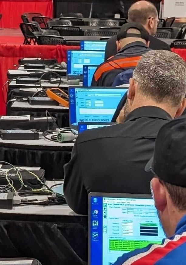 Heavy-duty truck technicians competing in Mark Zachos cybersecurity challenge at the TMCSuperTech national skills competition.