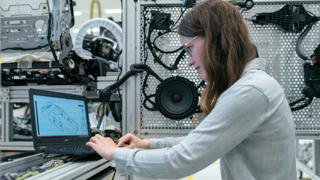Graduate students working in the Vehicle Cyber Engineering lab at University of Detroit Mercy learning vehicle-cybersecurity-standards